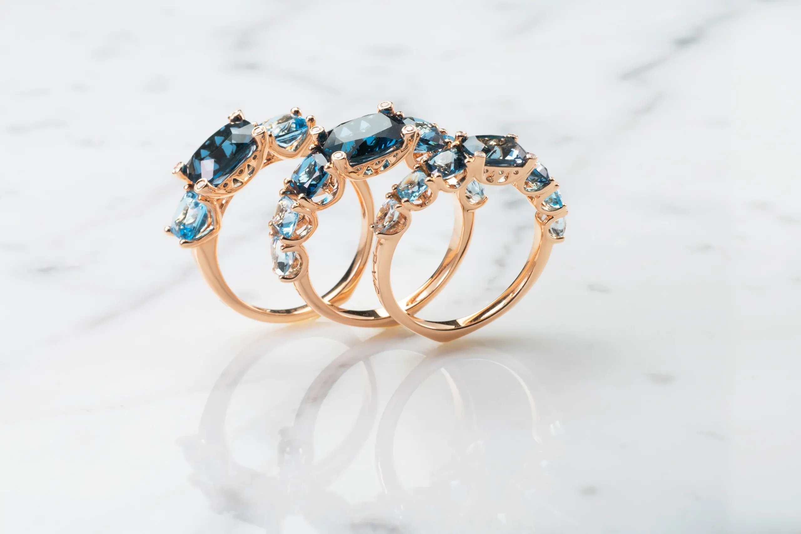 Three Iris rings with blue topaz on marble – Ponte Vecchio Gioielli