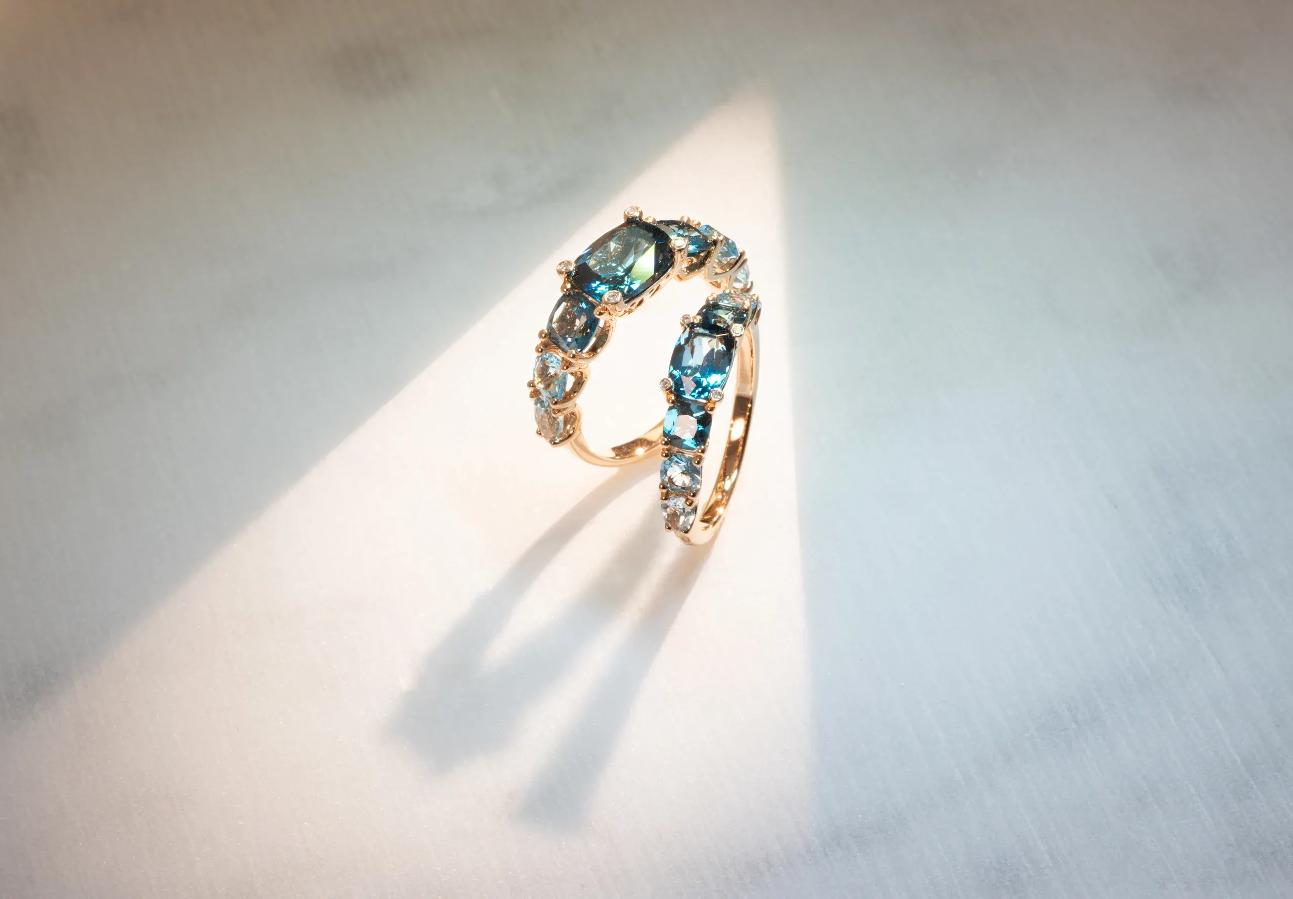 Three Iris rings with blue topaz against the light – Ponte Vecchio Gioielli