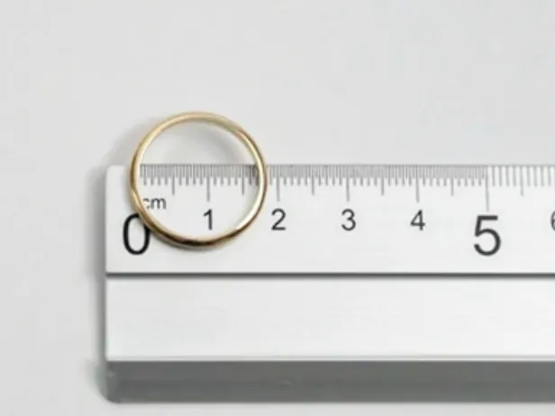 Ring on a ruler Biscioni Gioielli ring leaning on a ruler to take the correct measurement on a white background