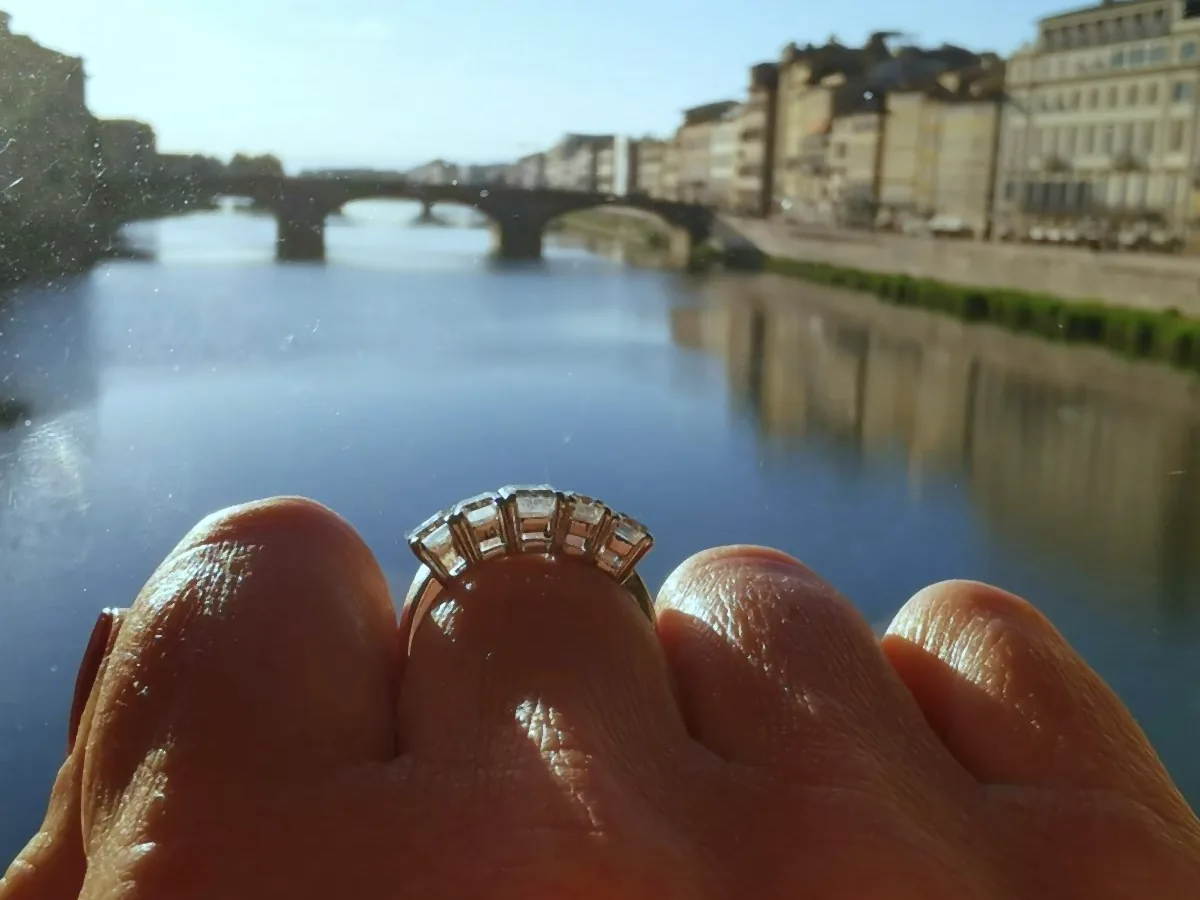 A ring with a row of stones worn in front of the Arno and Ponte Santa Trinita